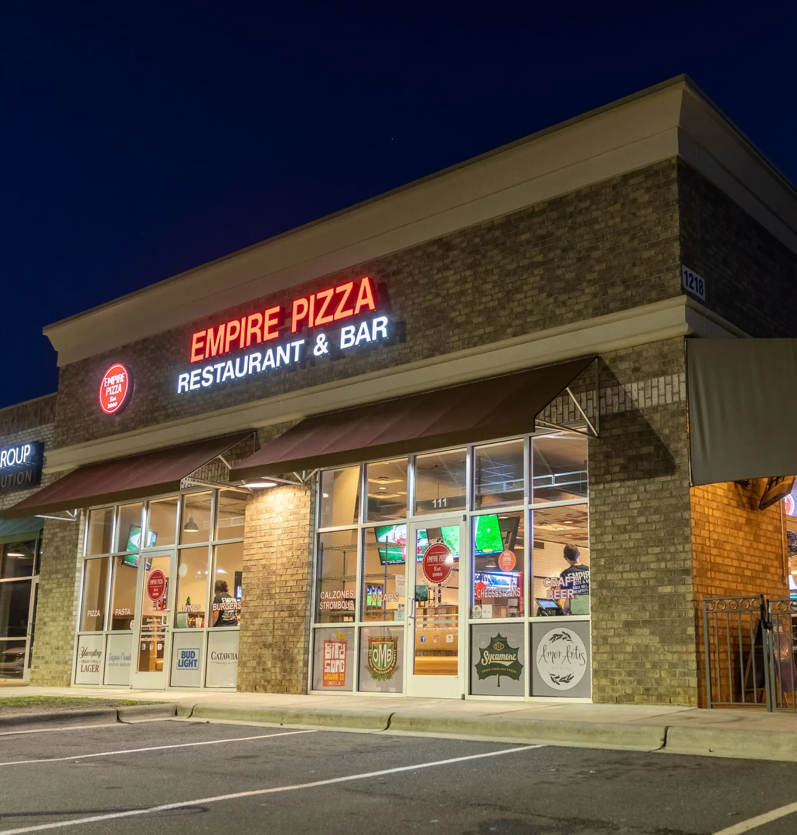 Empire Pizza Restaurant & Bar storefront in Mint Hill, NC at night