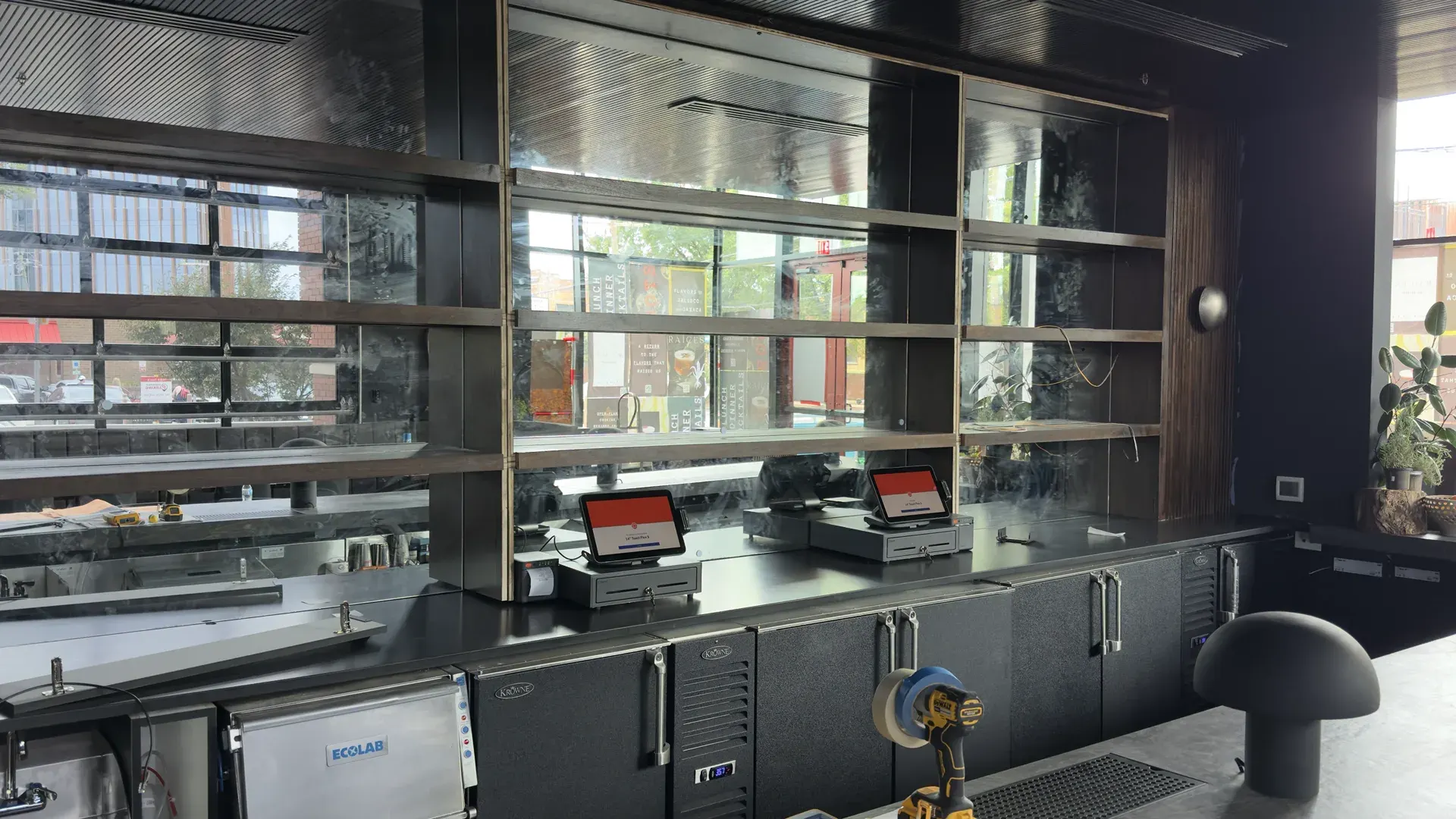 Toast POS terminals installed on the bar at Raíces Restaurant in Charlotte during the build-out